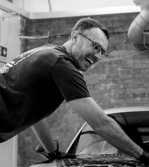 Ben from BB Detailing working on a car in his unit